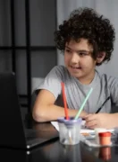 young-kid-painting-with-watercolor_23-2149432879